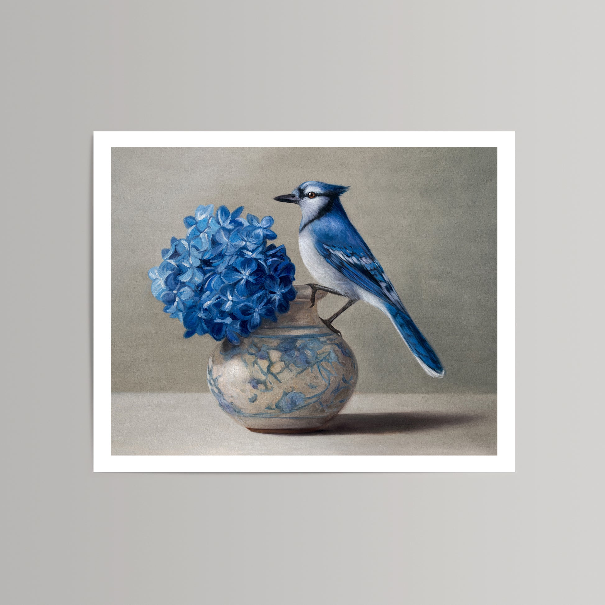 Fine art print: blue jay perched on a decorative vase with vibrant blue hydrangeas.