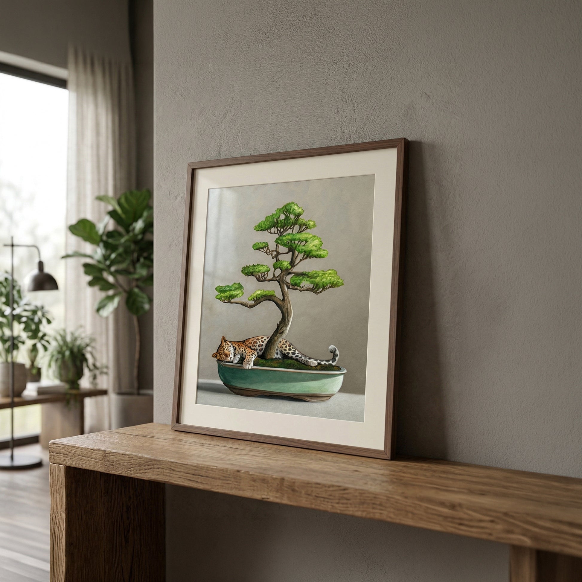 Framed fine art print featuring a leopard sleeping under a green bonsai tree in a teal pot.
