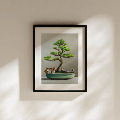 Framed fine art print of a sleeping leopard curled in a green bonsai pot under a vibrant green bonsai tree.