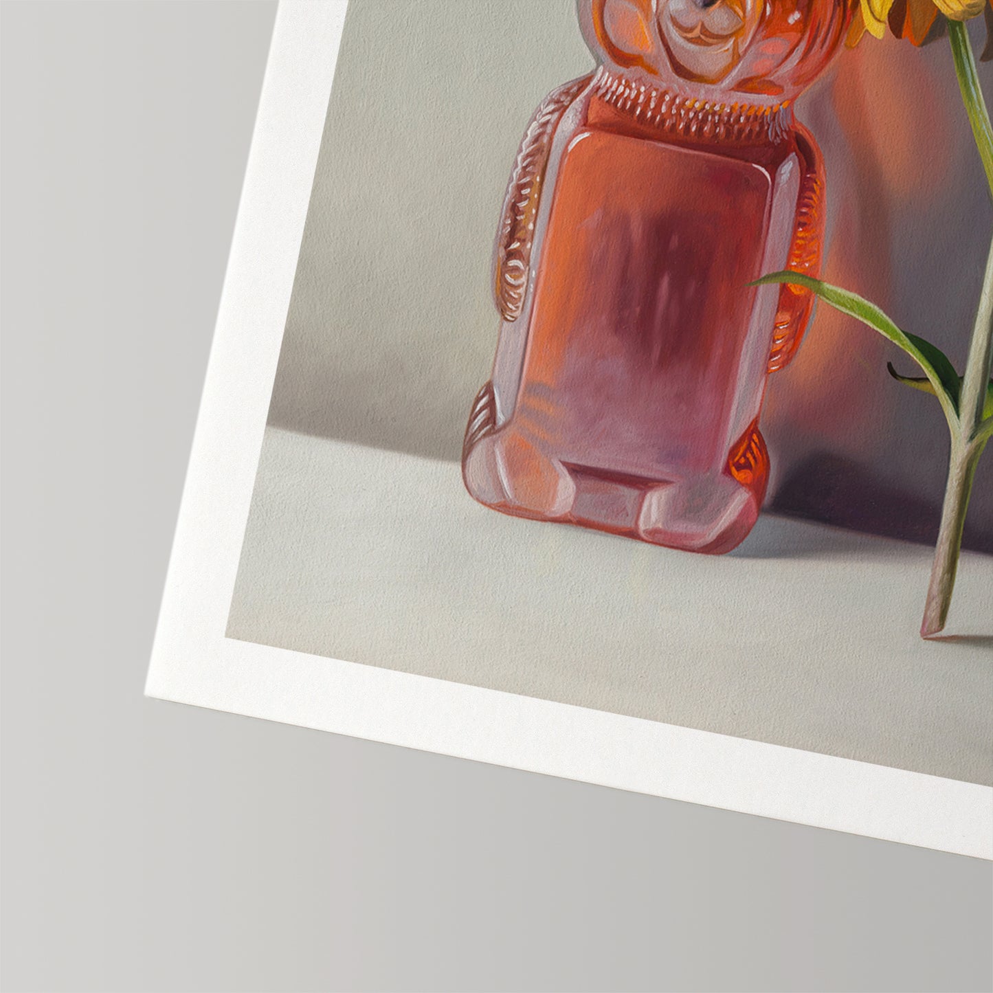 Fine art print of a honey bear bottle with amber honey and a sunflower on cotton rag paper.