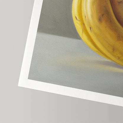Fine art print of yellow bananas on a gray background, with a white border on museum-grade paper.