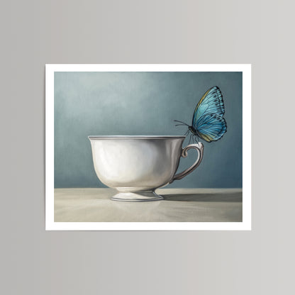 Fine art print of a vibrant blue butterfly perched on a white teacup against a soft blue background.