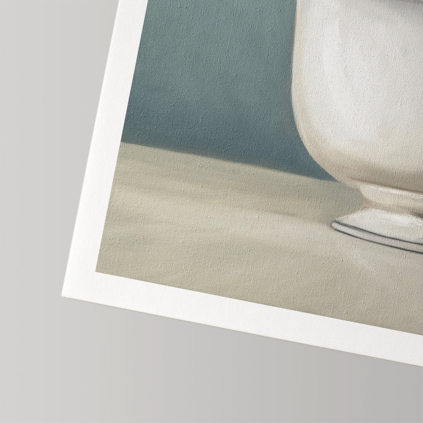 Close-up of a fine art print on textured cotton rag paper, featuring a white teacup against a blue-gray background.