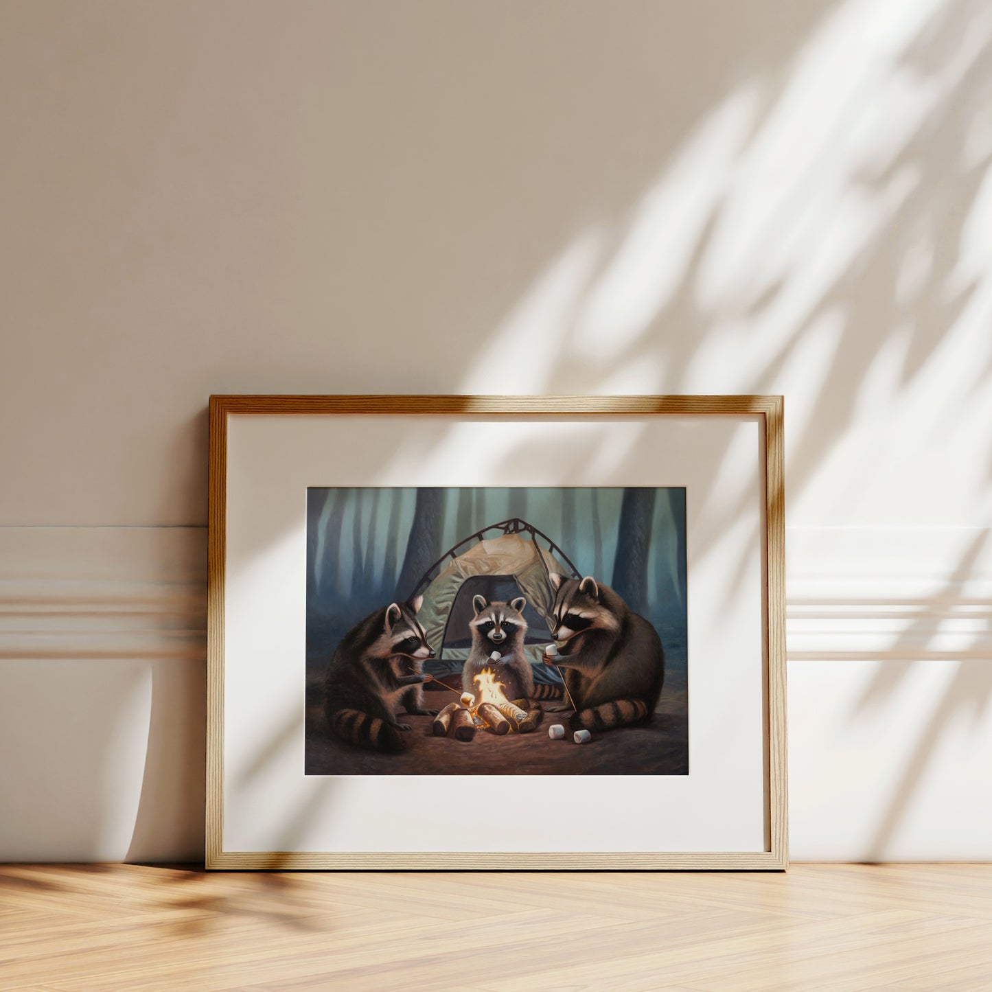 Framed fine art print of three raccoons camping, roasting marshmallows over a campfire in a forest.