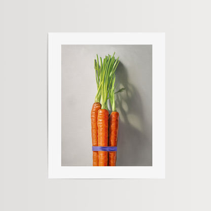 Carrot Bunch Fine Art Print by Lauren Pretorius: a bundle of carrots resting on a neutral grey surface with dramatic side lighting creating interesting cast shadows.