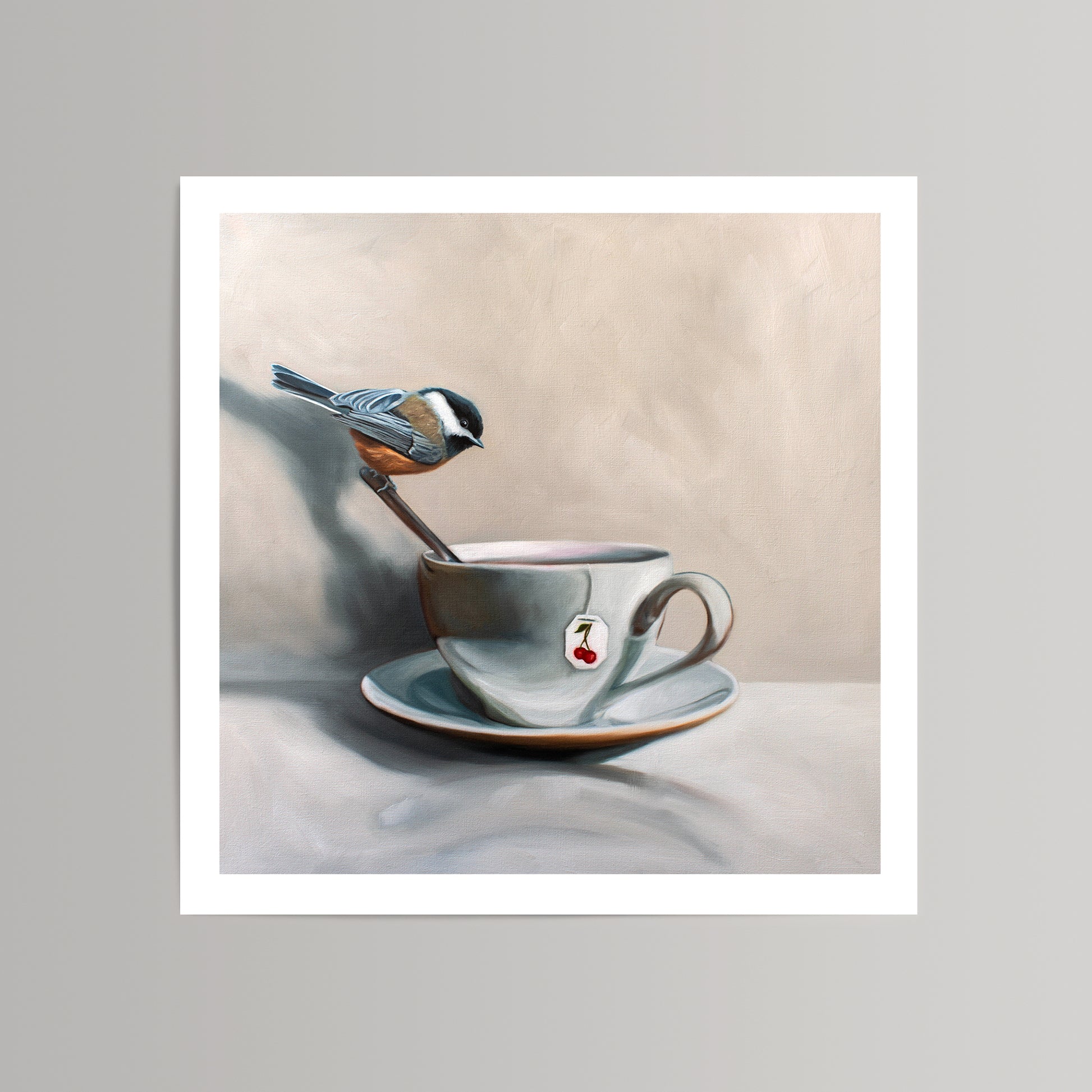 Fine art print of a chickadee perched on a spoon in a teacup with a cherry tea bag.