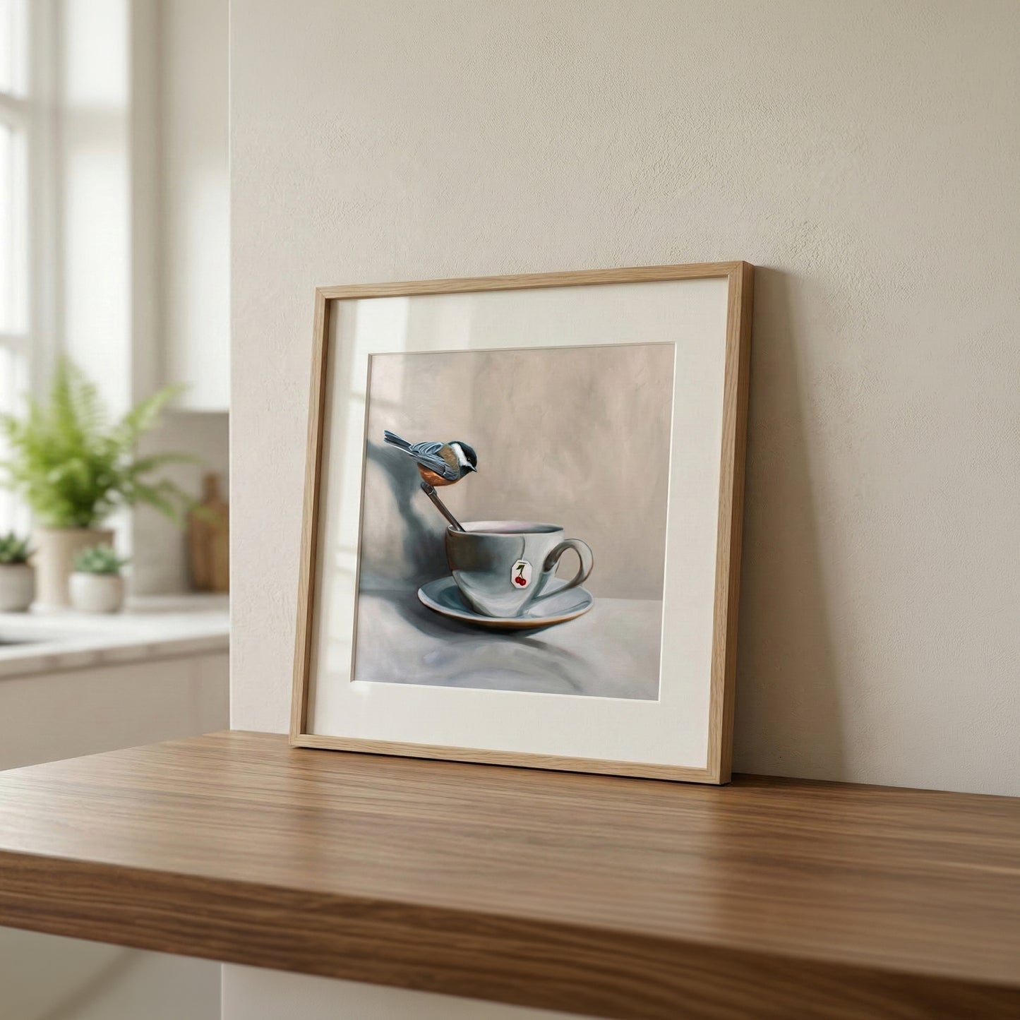 Framed fine art print of a chickadee perched on a spoon in a teacup with a cherry design.