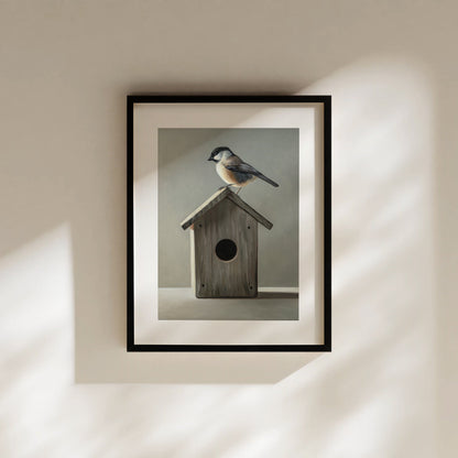 Chickadee & Birdhouse Fine Art Print by Lauren Pretorius: a Chickadee perched don top of a wooden bird house resting on a white surface with grey background.