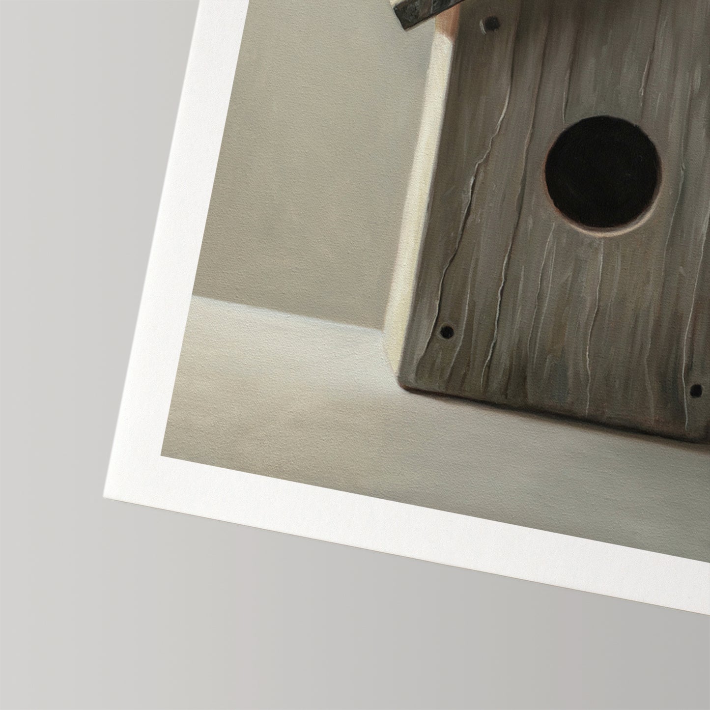 Fine art print of a rustic wooden birdhouse with a dark entry hole, featuring a white border.