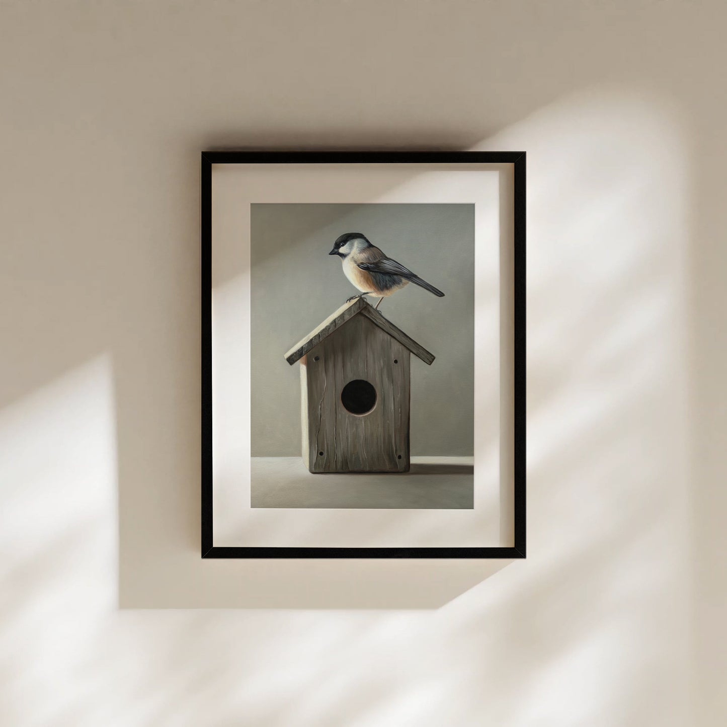 Framed fine art print of a chickadee perched on a rustic wooden birdhouse, featuring soft, natural colors.