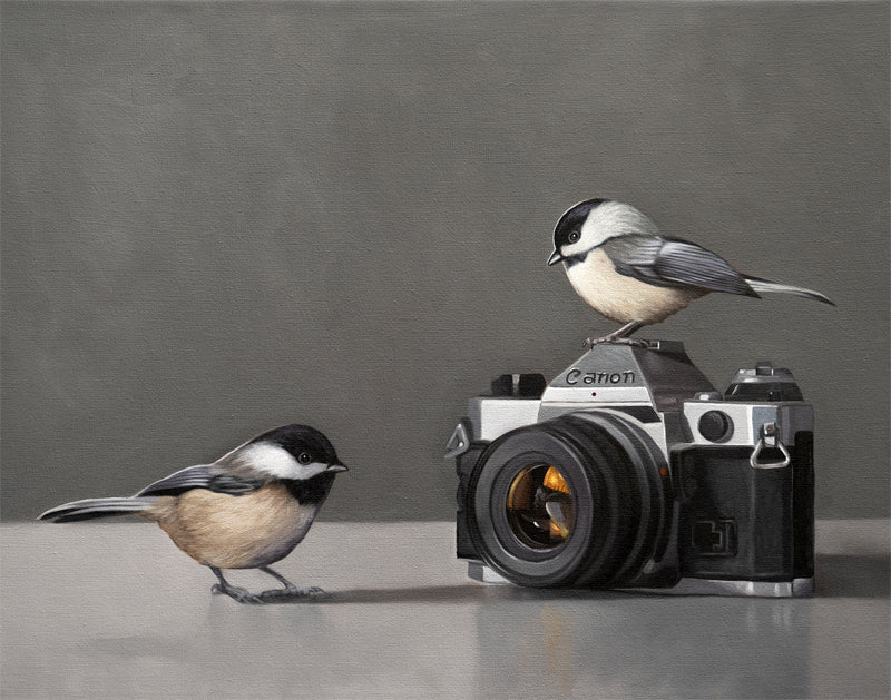 Fine art print of two chickadees with a vintage Canon camera on a gray background.