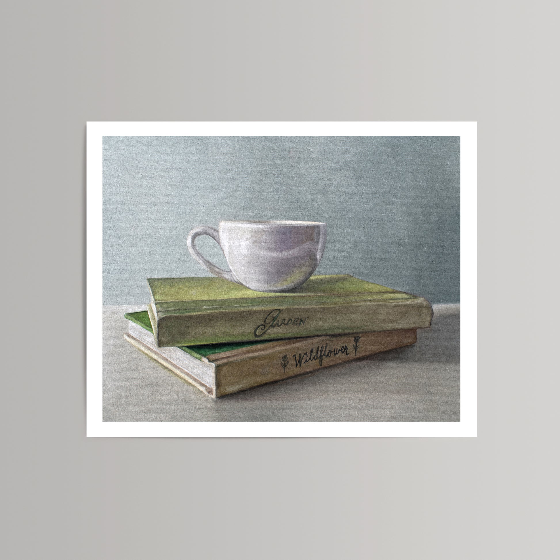 Fine art print of a white coffee cup resting on two stacked green and brown books with "Garden" and "Wildflower" titles.