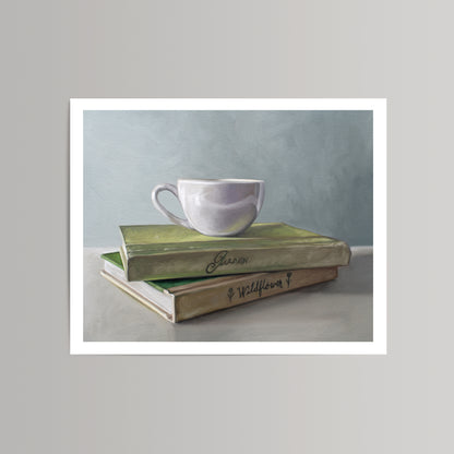 Fine art print of a white coffee cup resting on two stacked green and brown books with "Garden" and "Wildflower" titles.