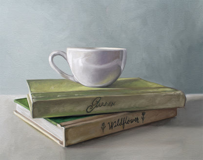 Still life painting of a white coffee cup resting on two stacked vintage-style books, "Garden" and "Wildflower.