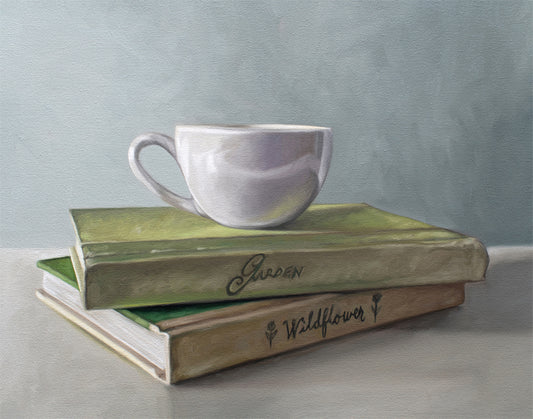 Still life painting of a white coffee cup resting on two stacked vintage-style books, "Garden" and "Wildflower.