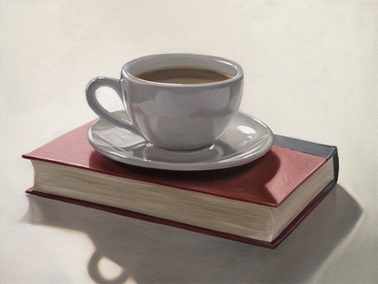 Coffee & Book Fine Art Print by Lauren Pretorius: a backlit coffee cup and saucer resting on top of a red book.