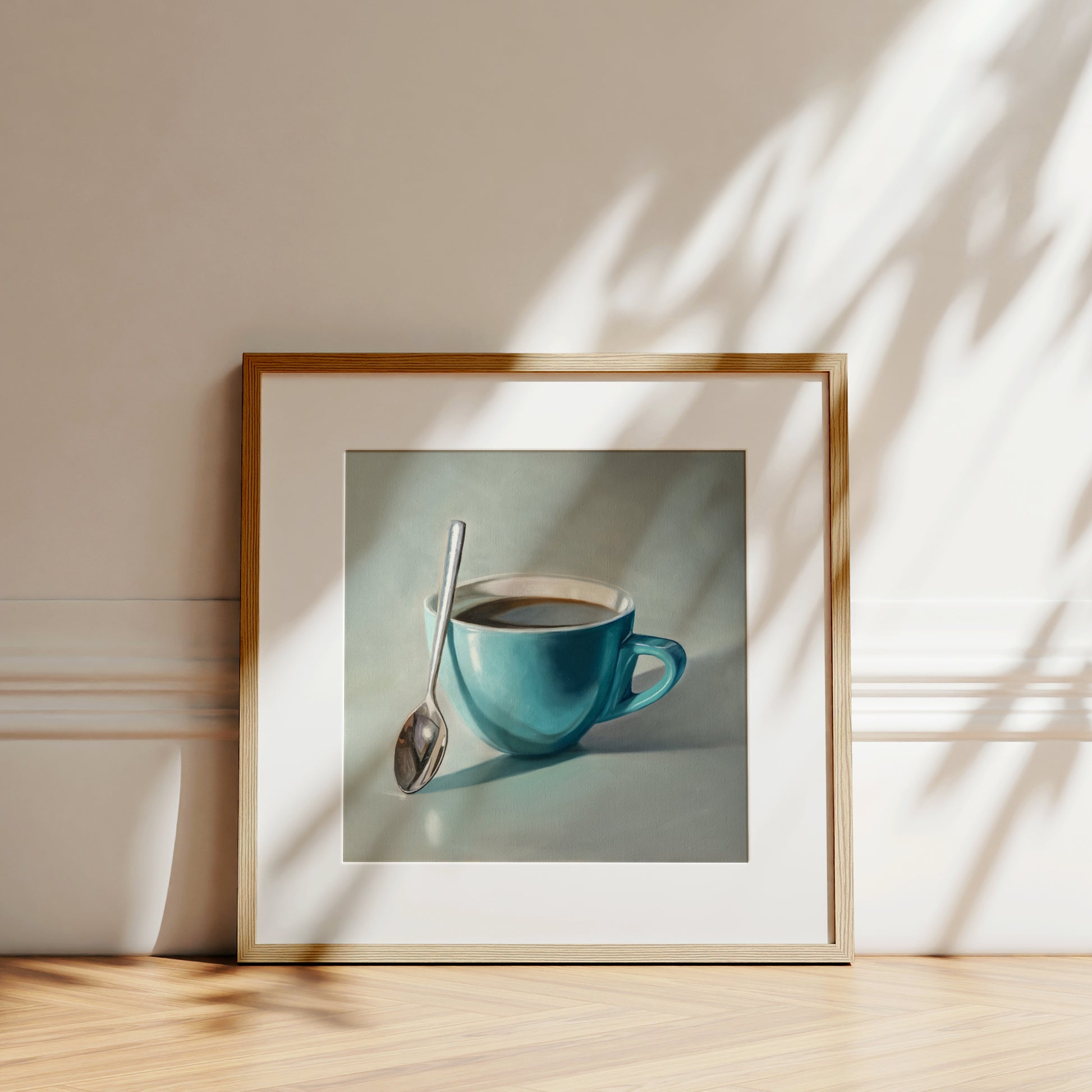 Coffee Cup & Spoon Fine Art Print by Lauren Pretorius: a blue cup of coffee with a spoon resting on the cup.