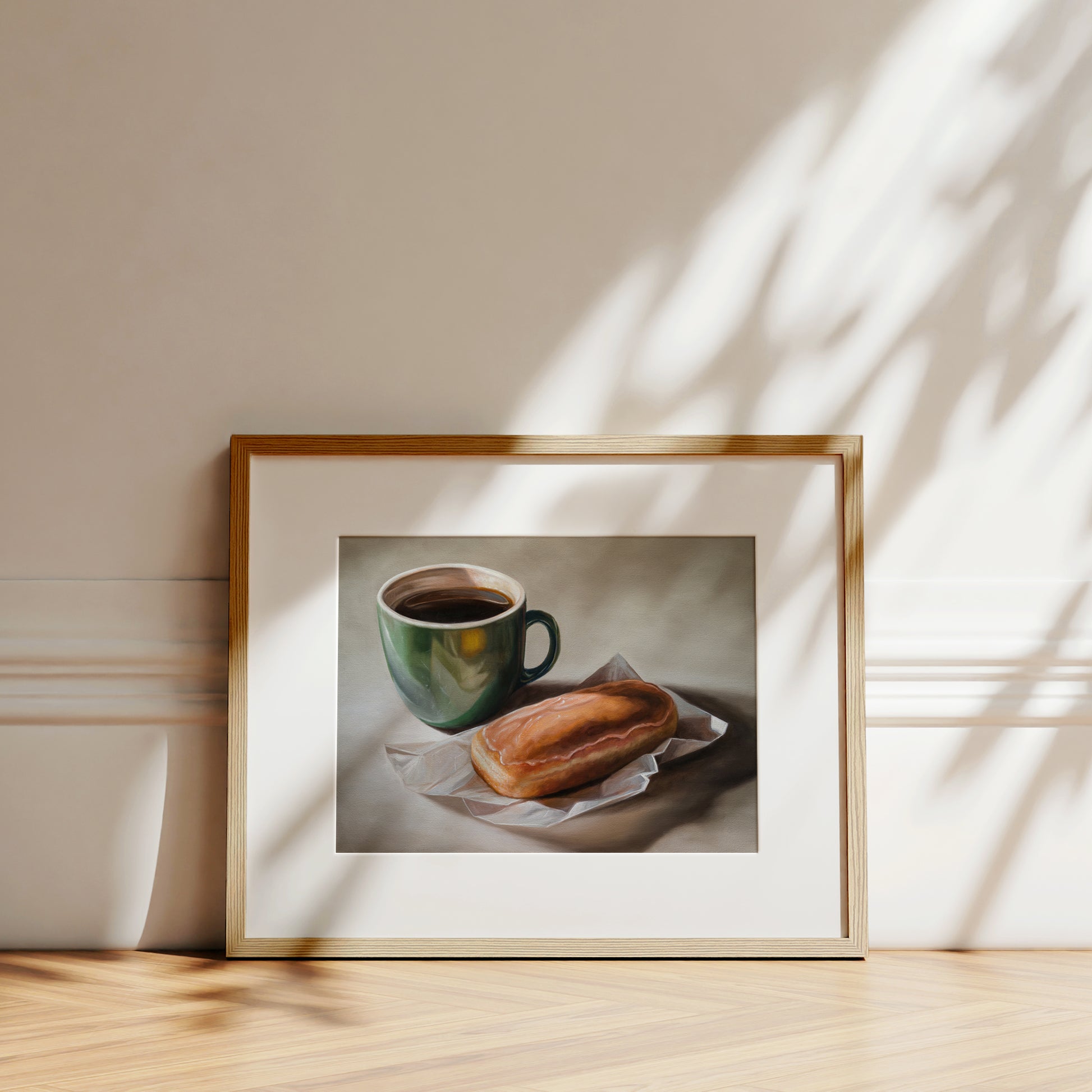 Coffee & Maple Bar Donut Fine Art Print by Lauren Pretorius: a coffee cup and a maple bar donut placed on a paper wrapper, with a cup of coffee.