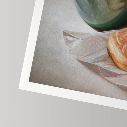 Fine art print of a warm glazed donut on white paper, next to a green coffee cup.
