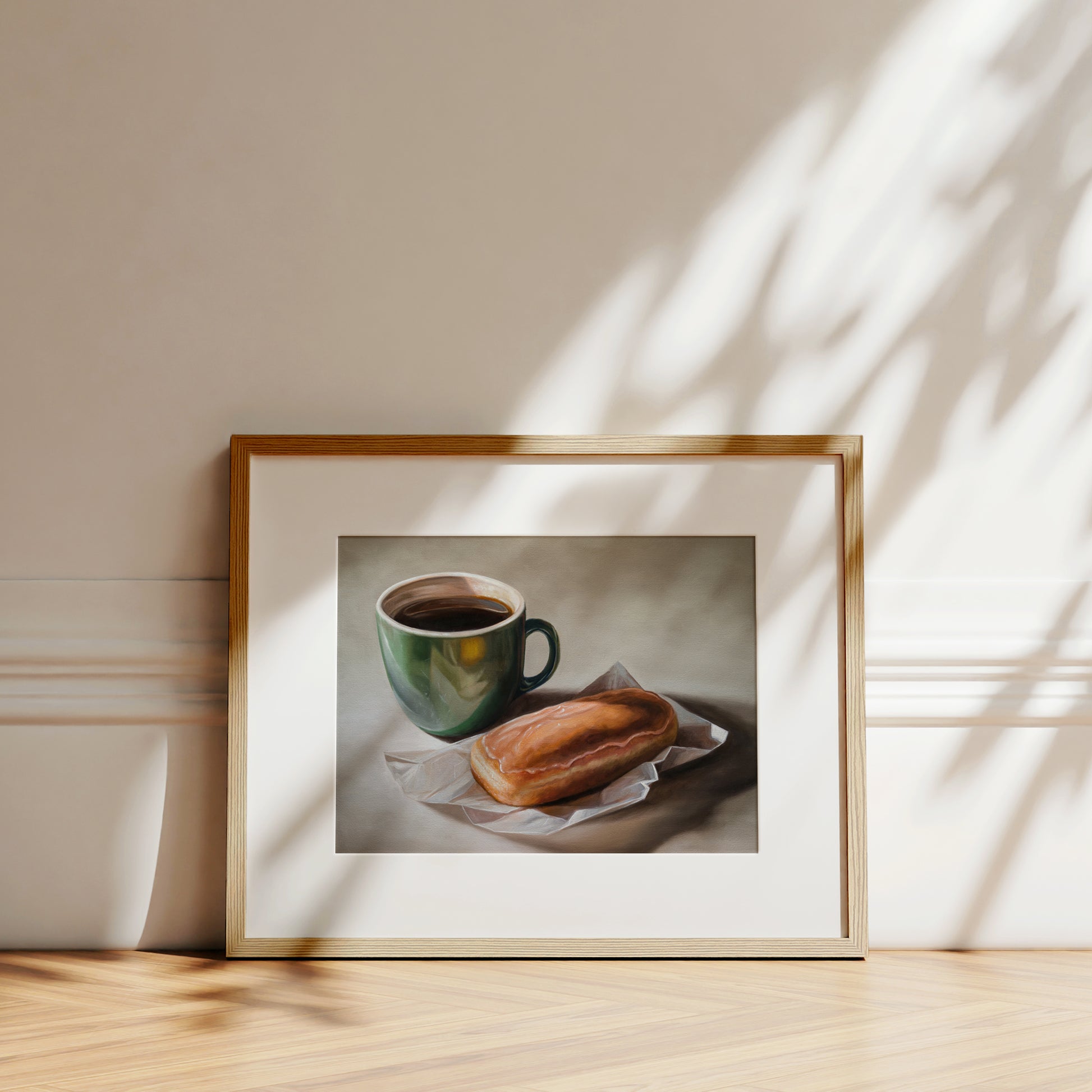 Framed fine art print of a coffee cup and maple bar donut, with natural light and shadows.