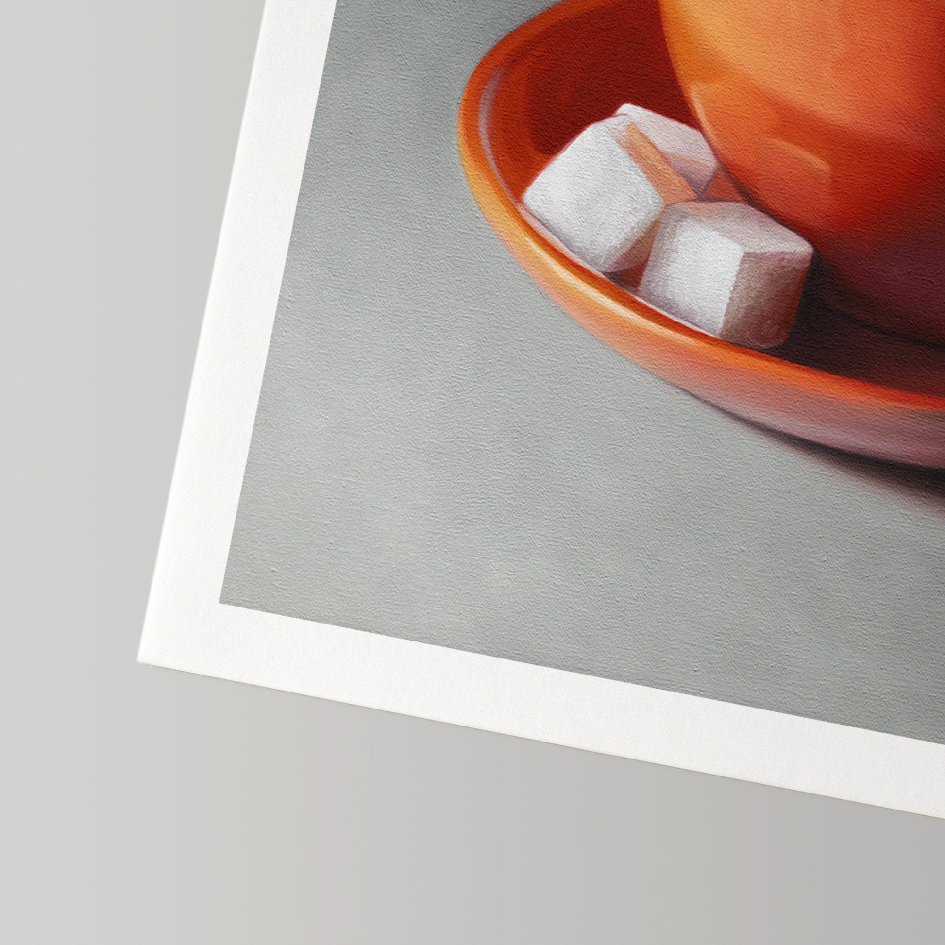 Fine art print of a vibrant orange coffee cup with two white sugar cubes on a matching saucer.