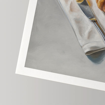 Fine art print of a croissant and butter on a white cloth, with a white border.