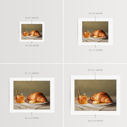 Croissant, Honey & Butter Fine Art Print by Lauren Pretorius: a croissant with honey and butter on a plate.