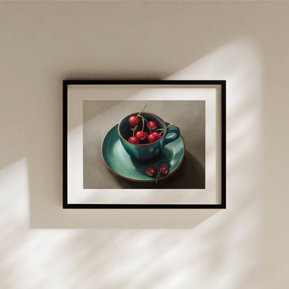 Cup of Cherries Fine Art Print by Lauren Pretorius: red cherries inside a blue green ceramic cup with a matching saucer, with a few cherries scattered outside the cup on a grey surface.