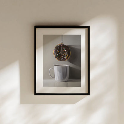 Framed fine art print of a chocolate donut with sprinkles hanging above a white coffee mug.