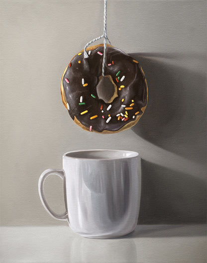 Fine art print of a chocolate donut with sprinkles hanging above a white coffee mug.