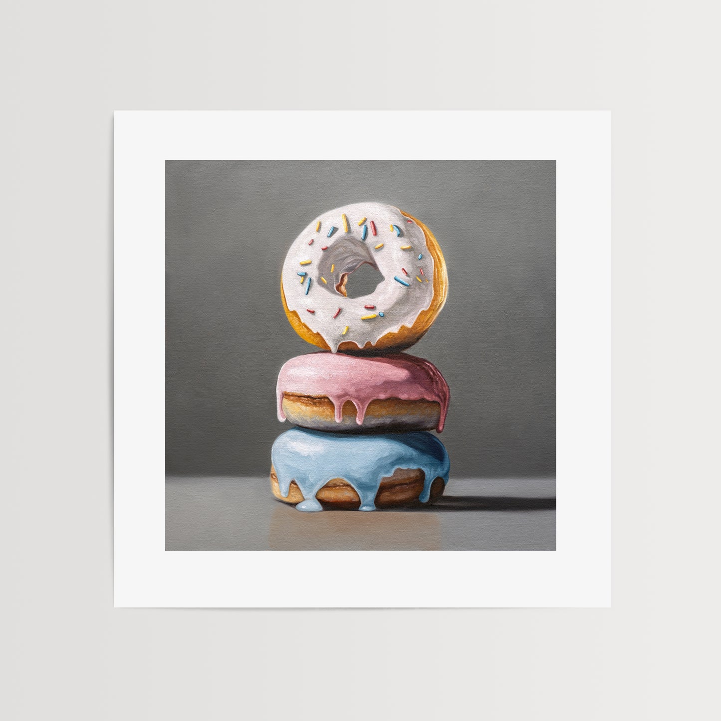 Donut Stack Trio Fine Art Print by Lauren Pretorius: a trio of donuts with different colored frosting stacked top of each other.