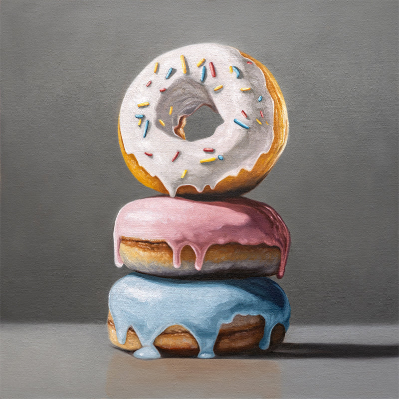 Donut Stack Trio Fine Art Print by Lauren Pretorius: a trio of donuts with different colored frosting stacked top of each other.
