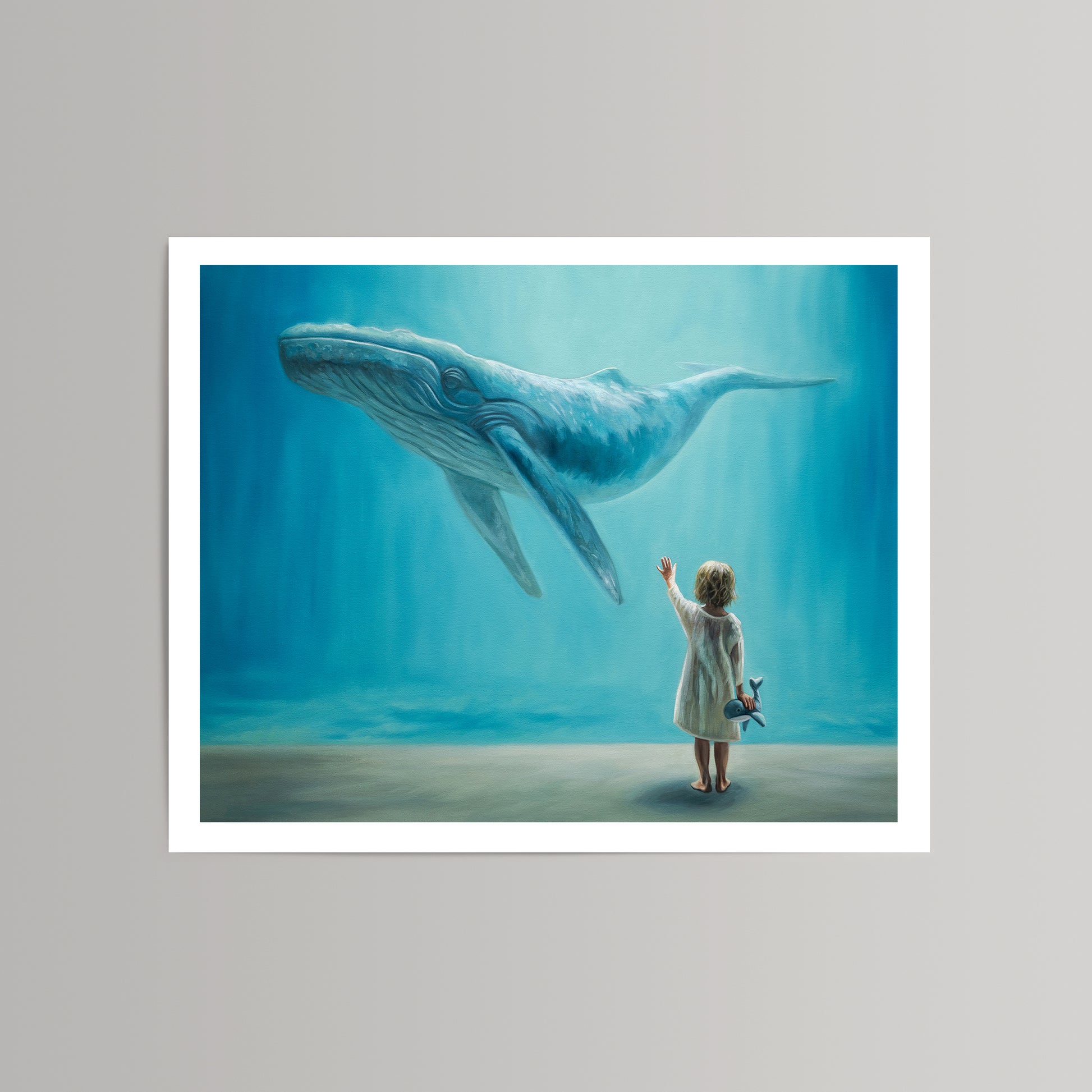 Fine art print: child in white dress reaching for a blue whale underwater, holding a small toy whale.