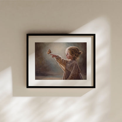 Girl with Butterfly Fine Art Print by Lauren Pretorius: a young girl reaching out to touch a butterfly against a soft, blurred background.