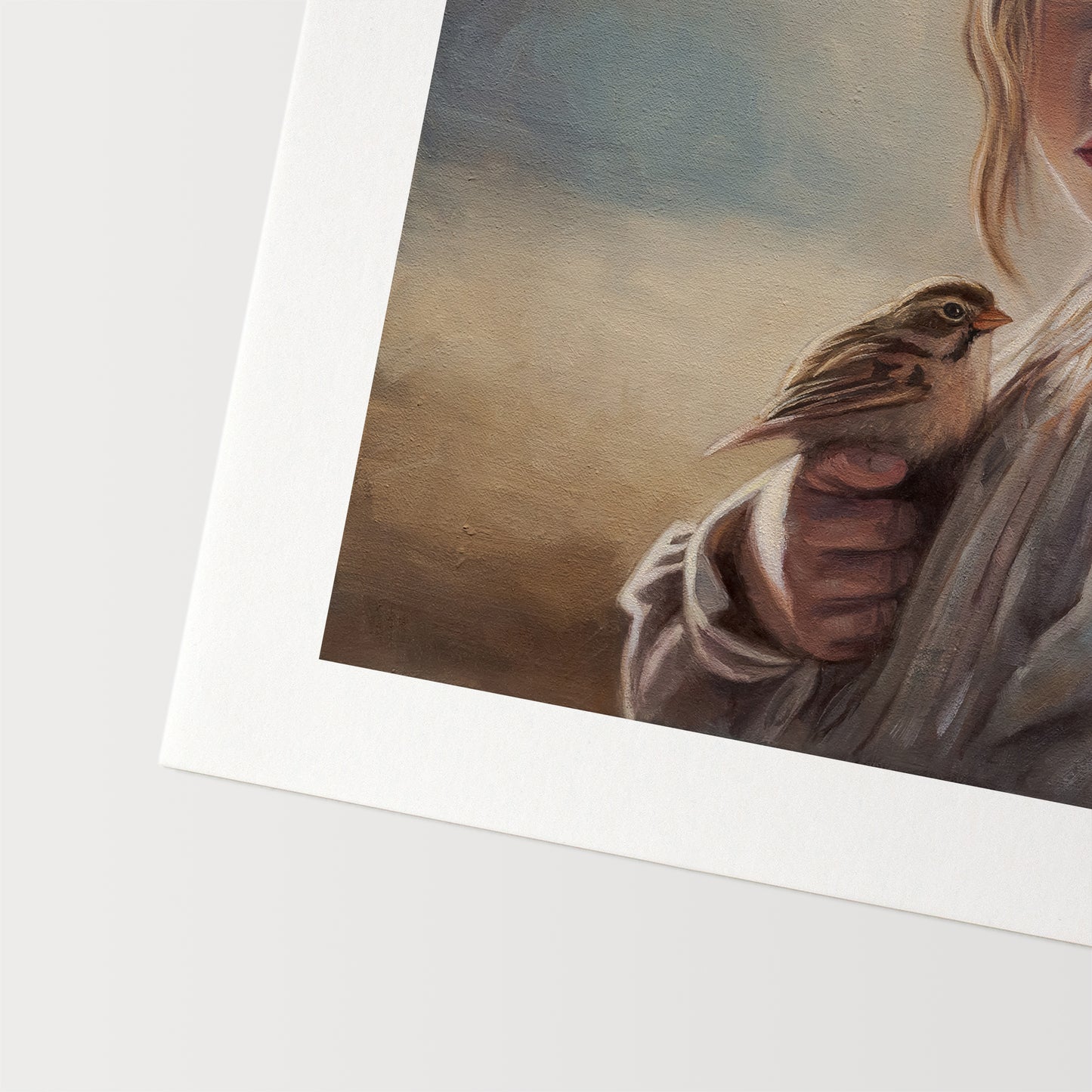 Girl with Sparrow Fine Art Print by Lauren Pretorius: a young girl holding a bird with a soft, warm color palette.