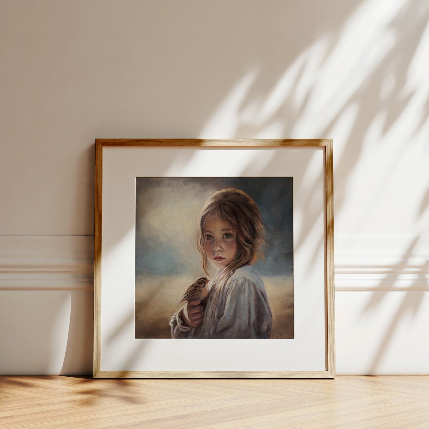 Girl with Sparrow Fine Art Print by Lauren Pretorius: a young girl holding a bird with a soft, warm color palette.