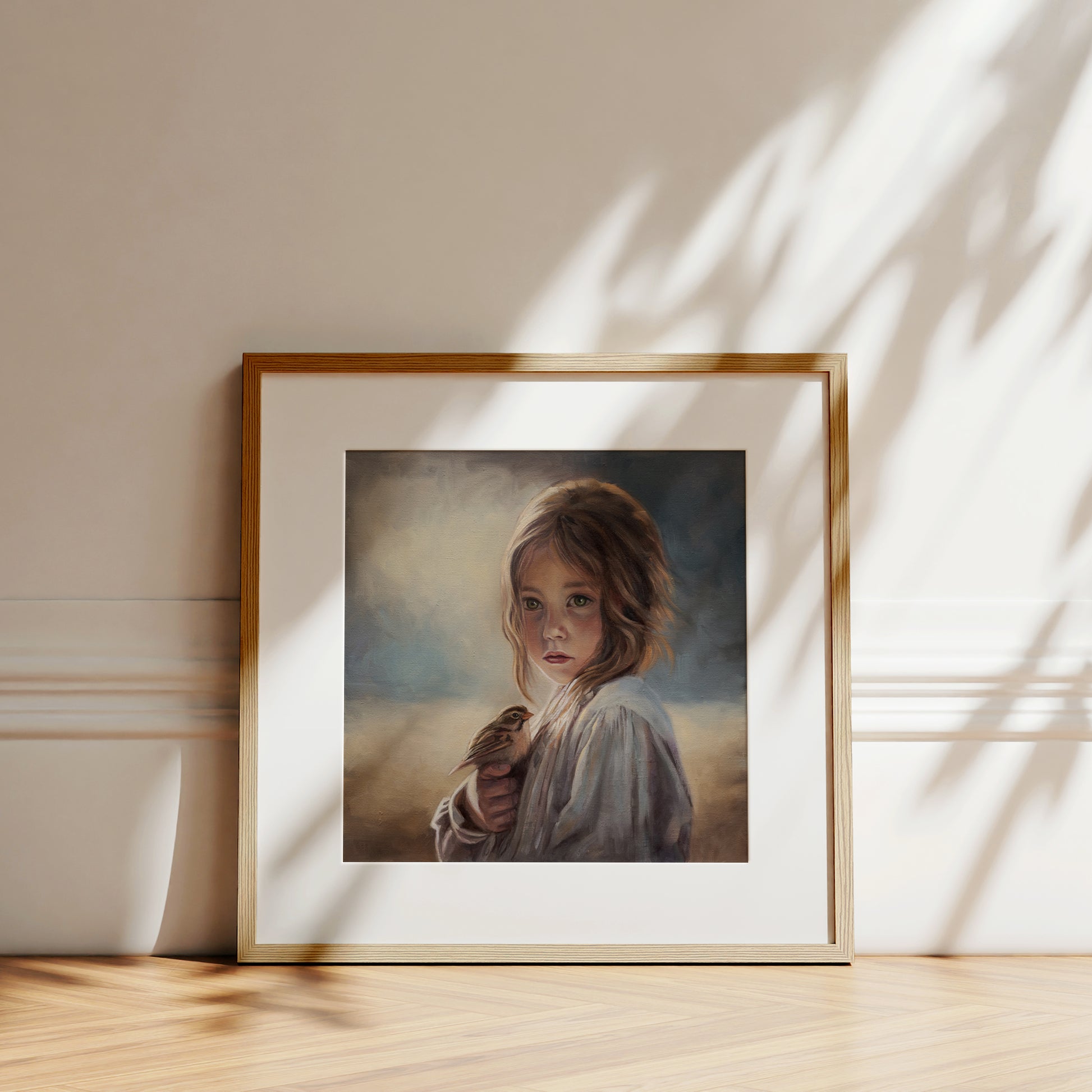 Girl with Sparrow Fine Art Print by Lauren Pretorius: a young girl holding a bird with a soft, warm color palette.