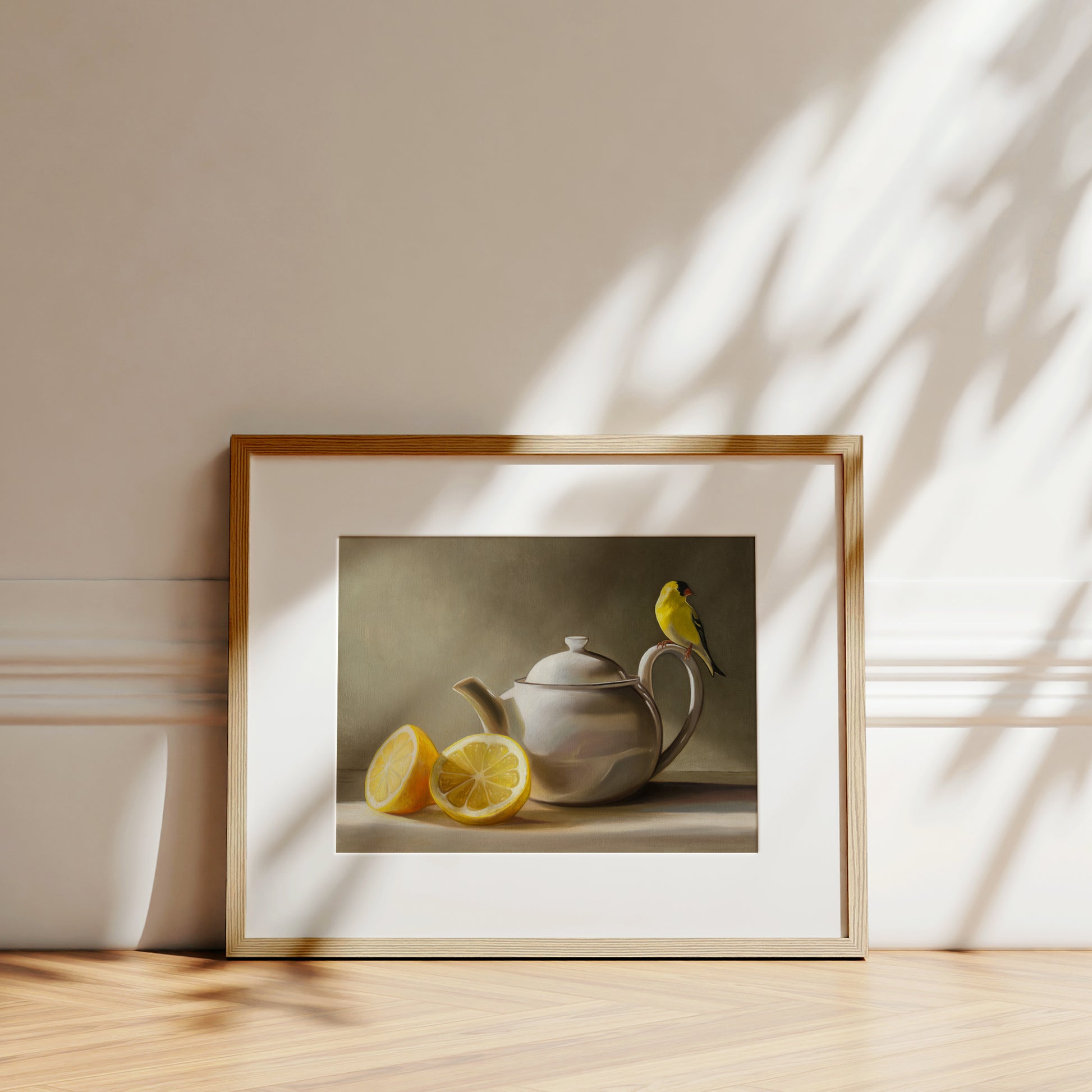 Goldfinch & Teapot Fine Art Print by Lauren Pretorius: a goldfinch perched on the handle of a teapot with two lemons on the left.