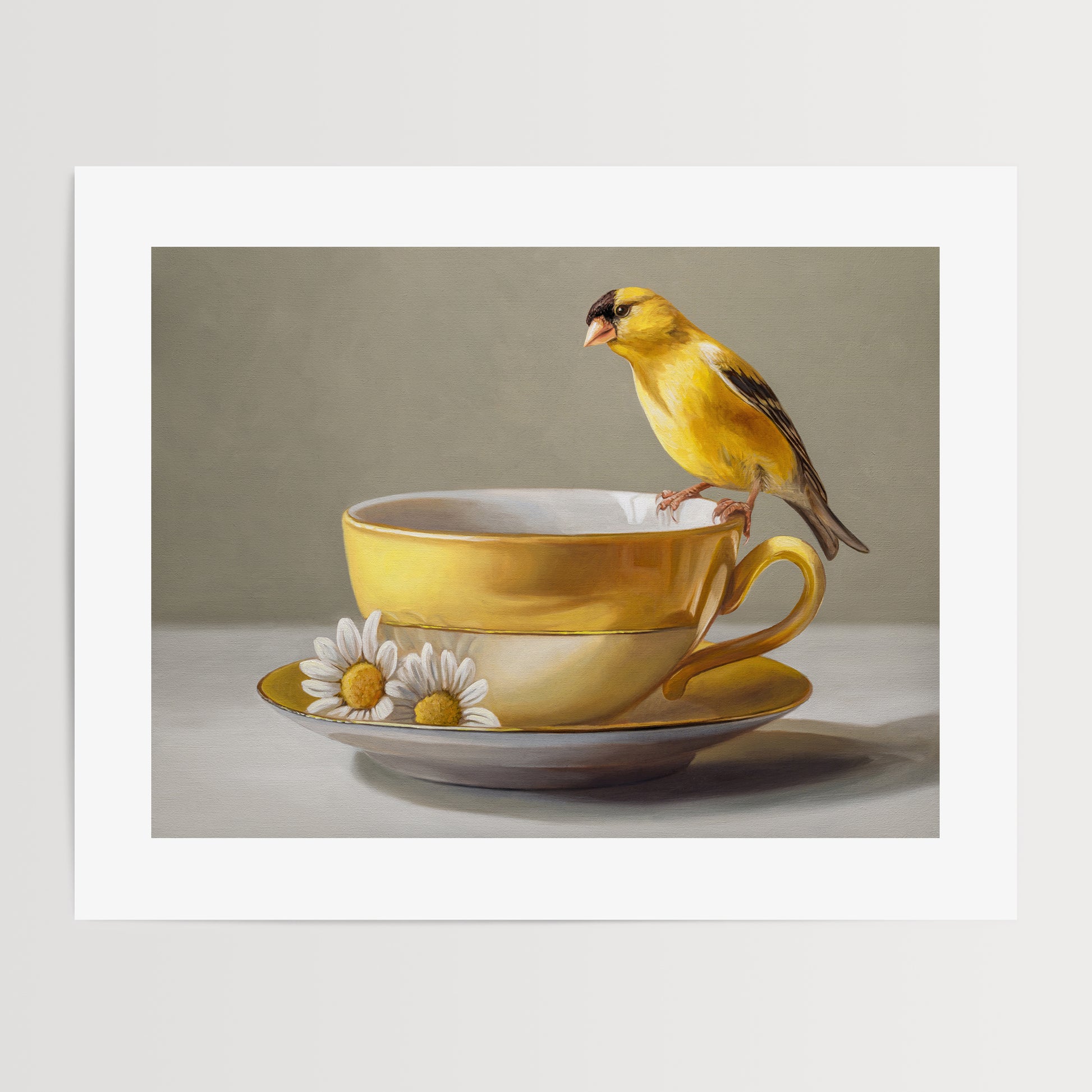 Goldfinch & Yellow Cup Fine Art Print by Lauren Pretorius: a goldfinch perched on a gold teacup with white flowers on a saucer against a neutral background
