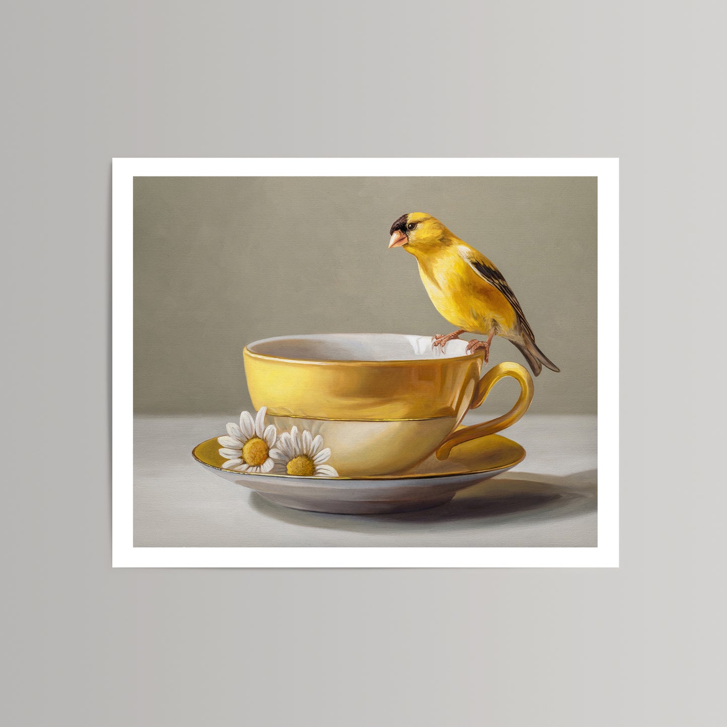 Vibrant yellow goldfinch perched on a yellow teacup and saucer with white daisies, fine art print.