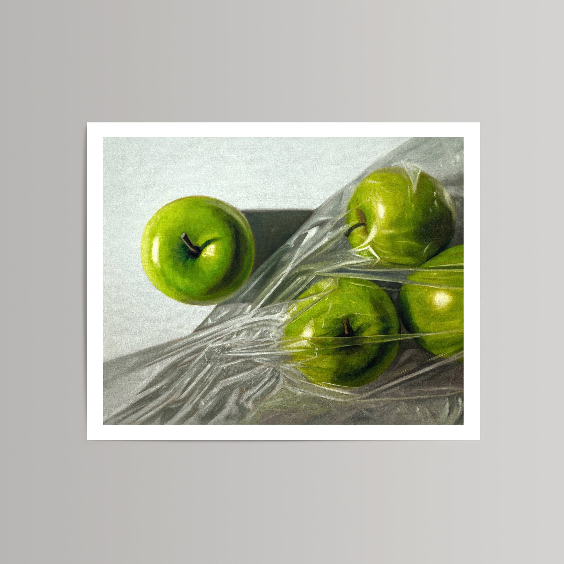 Fine art print of vibrant green Granny Smith apples, one unwrapped, three in crinkled plastic.
