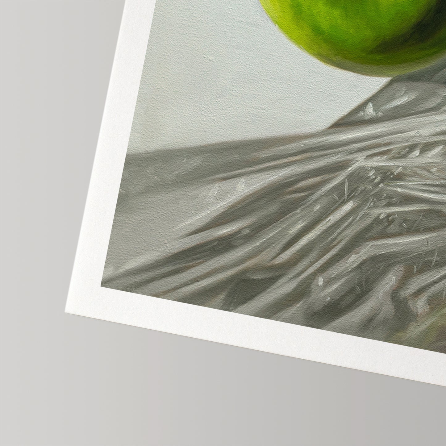 Fine art print of a vibrant green Granny Smith apple on a textured surface, with a white border.