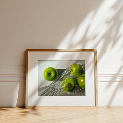 Framed fine art print of four vibrant green Granny Smith apples, one unwrapped, three in plastic.