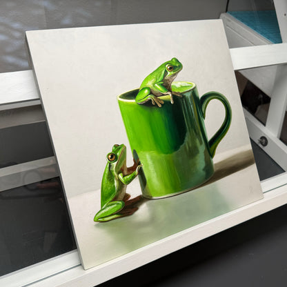 Green Frogs & Cup 12" x 12" Original Oil Painting by Lauren Pretorius: a green ceramic mug with a frog design on a light gray background
