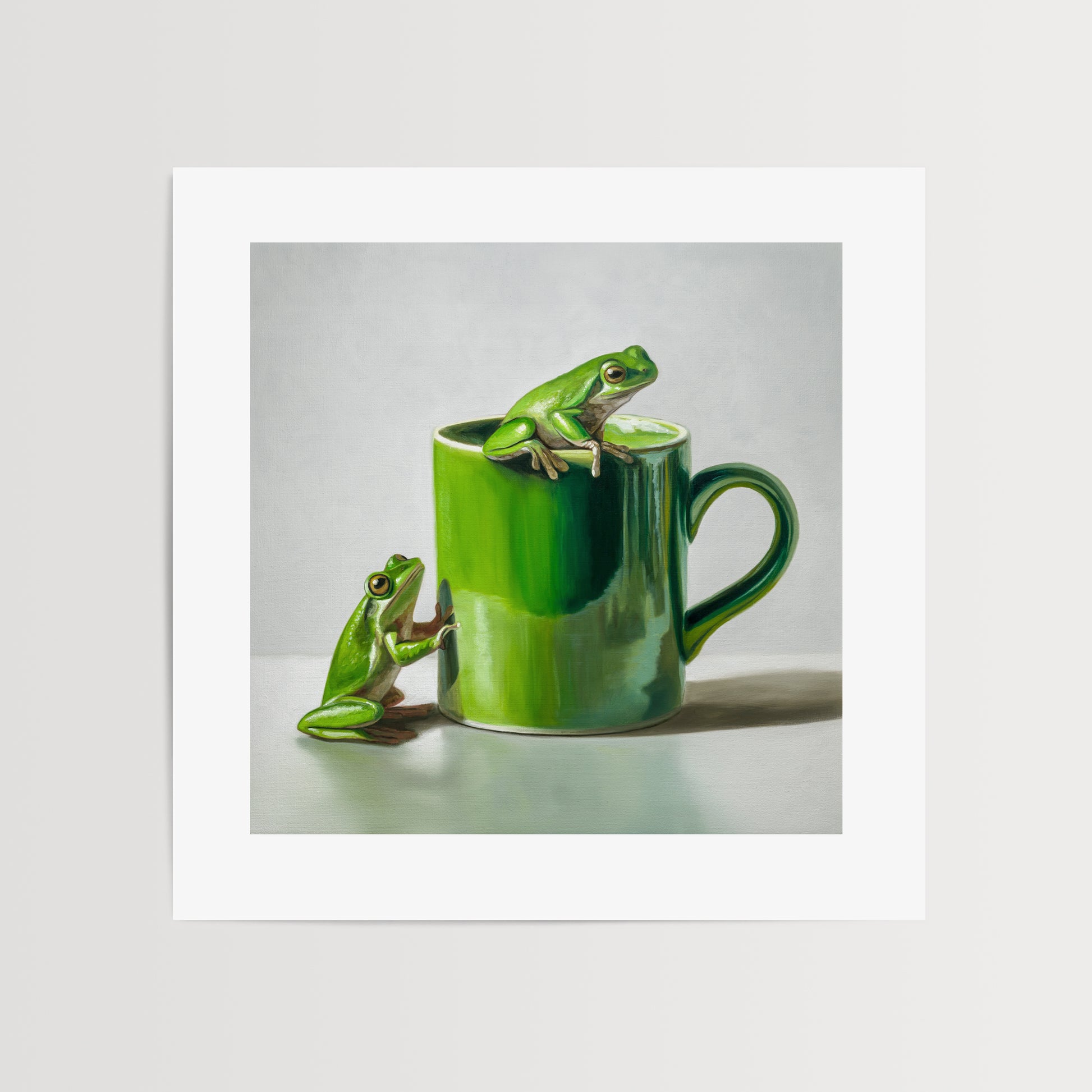 Green Frogs & Cup Fine Art Print by Lauren Pretorius: a green frog on a green mug against a light gray background