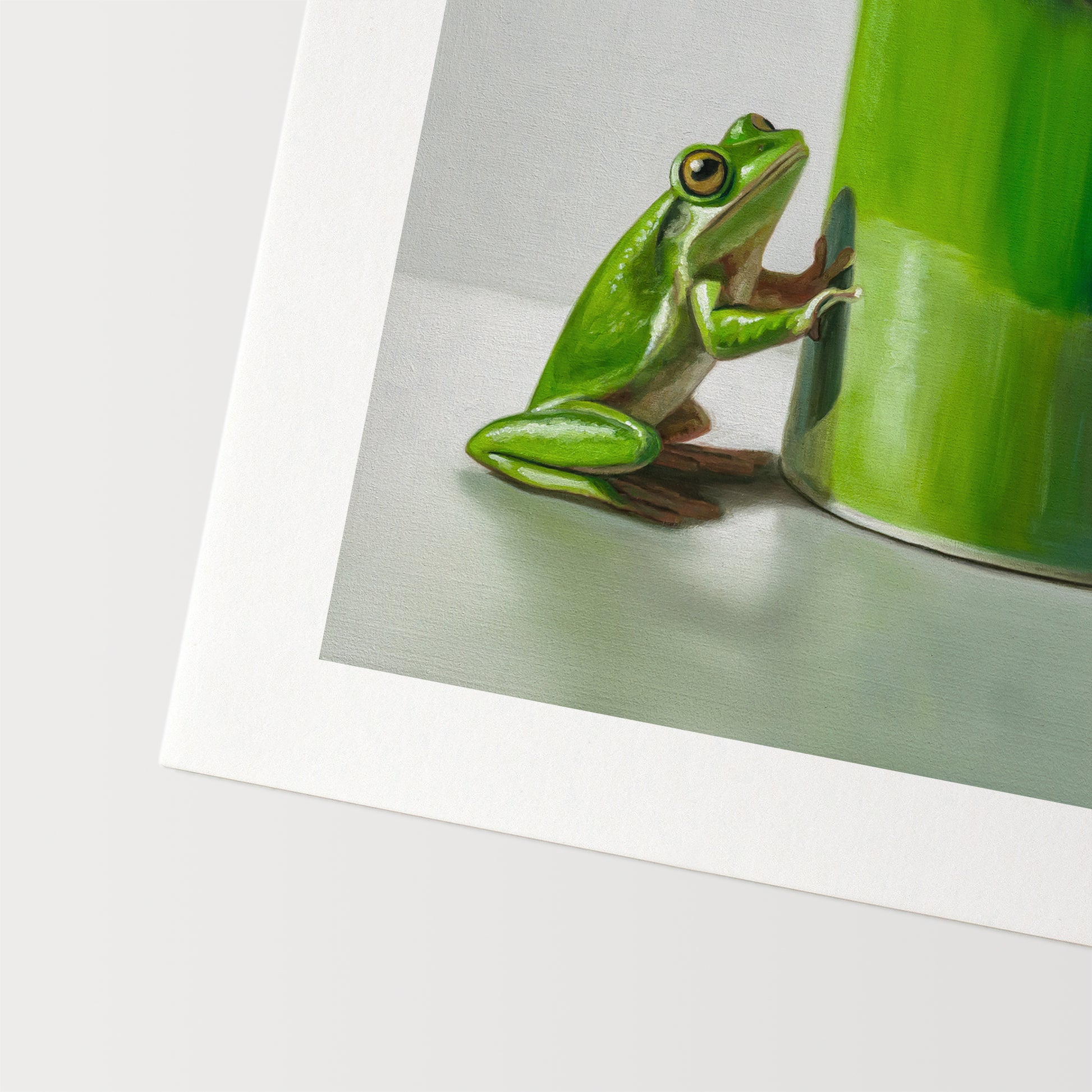 Green Frogs & Cup Fine Art Print by Lauren Pretorius: a green frog on a green mug against a light gray background
