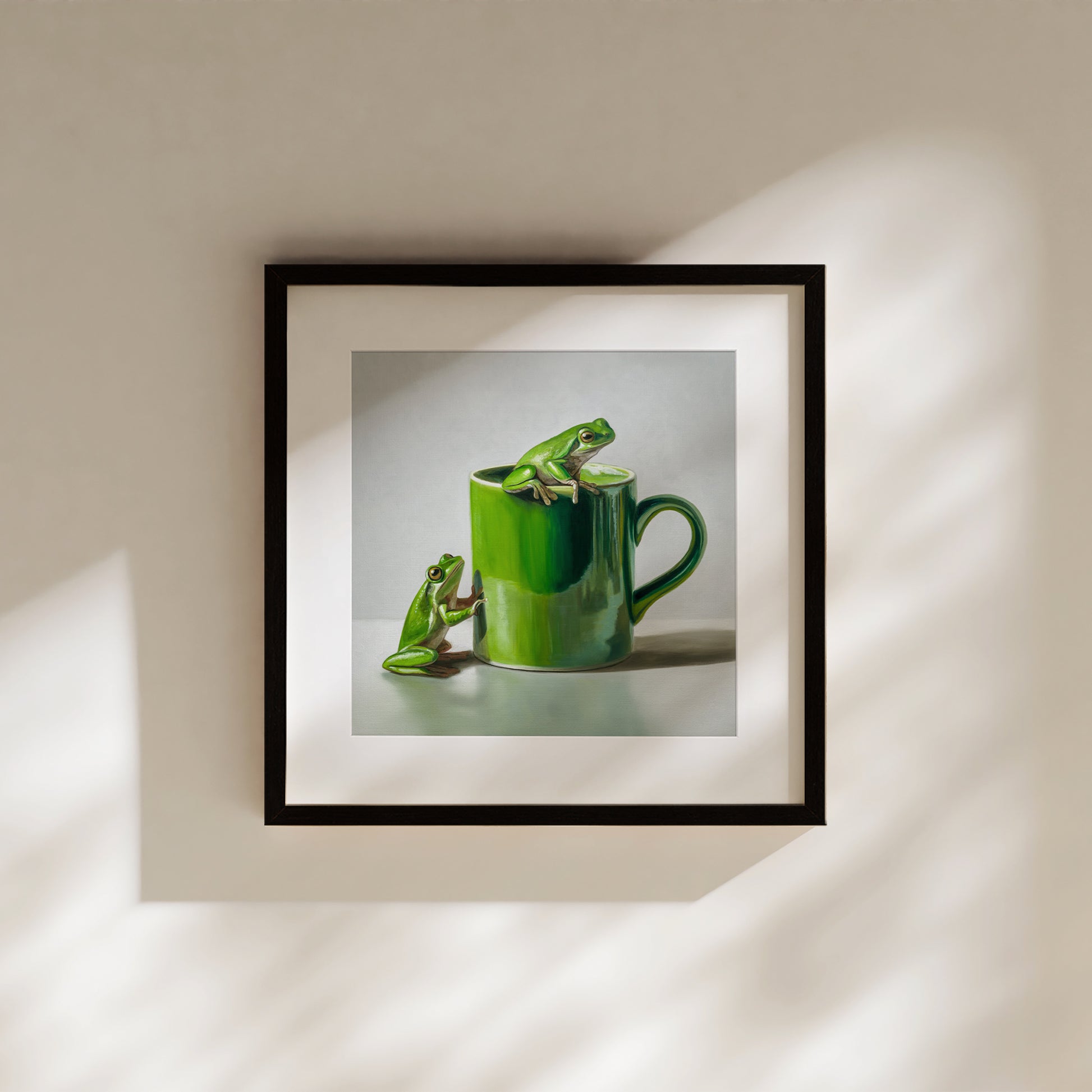 Green Frogs & Cup Fine Art Print by Lauren Pretorius: a green frog on a green mug against a light gray background