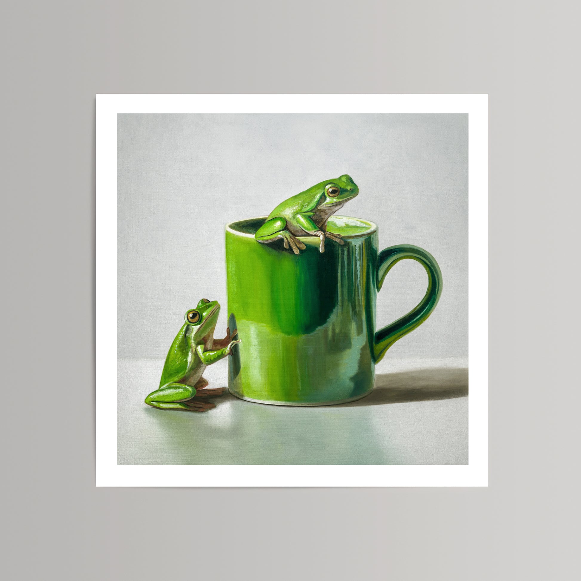 Vibrant green frogs on and beside a glossy green ceramic mug, fine art print on cotton rag paper.