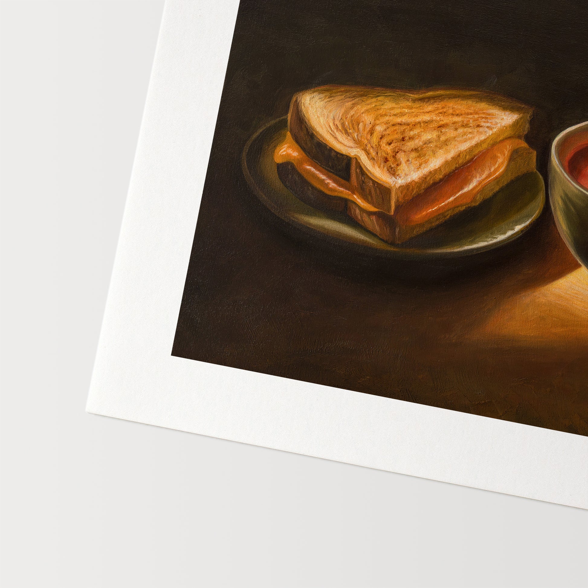 Grilled Cheese & Tomato Soup Fine Art Print by Lauren Pretorius: a bowl of tomato soup and a grilled cheese sandwich, with a spoon resting in the soup.