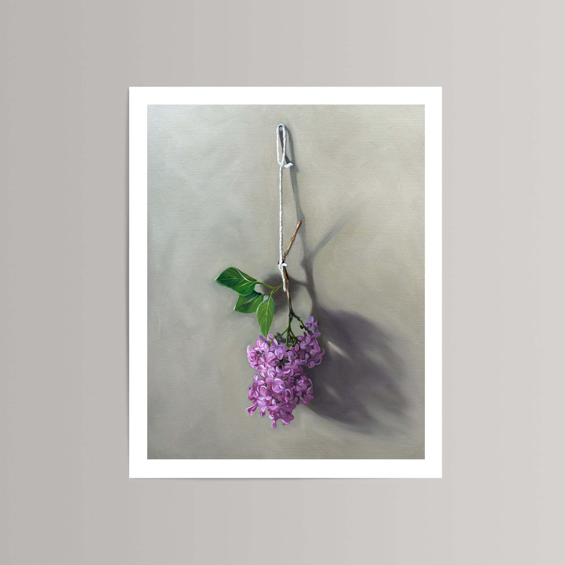 Fine art print of vibrant purple lilac blossoms hanging from a string against a neutral background.